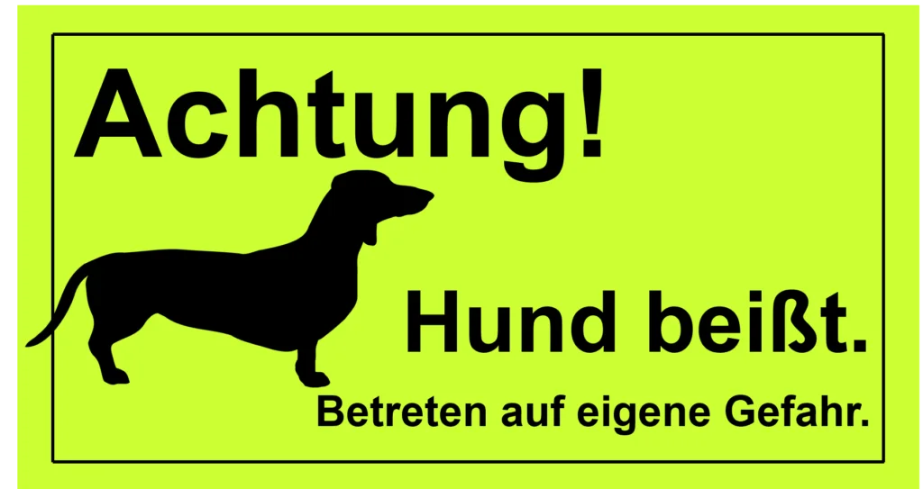 Warnschild mit der Aufschrift: „Achtung! Hund beißt.“ Es handelt sich um das generelle Präsens.